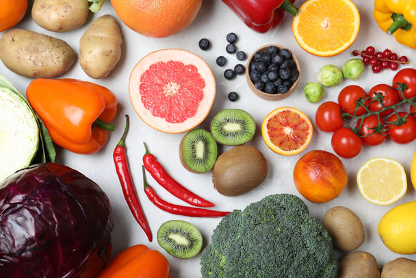 Fresh products rich in vitamin C on light table, flat lay - Valokuva, kuva