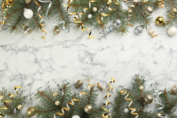 Serpentine streamers and Christmas decor on white marble background, flat lay. Space for text - 写真・画像