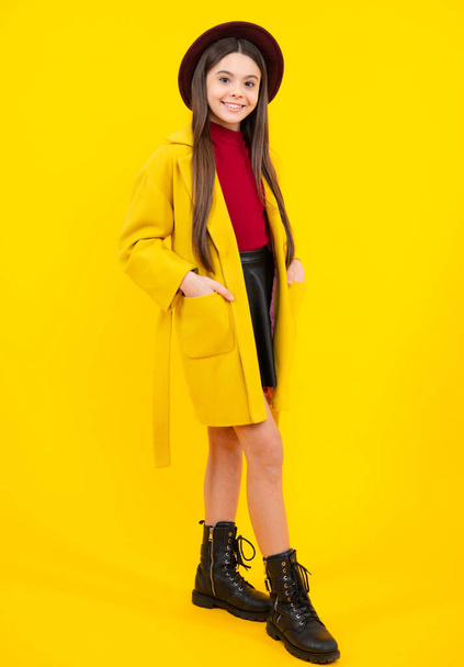 Elegant fashion teenager child girl in autumn coat posing in studio. Trends kids clothes. Happy teenager portrait. Smiling girl - Photo, image
