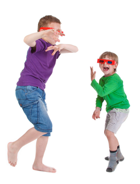 Two boys having fun wearing 3D glasses - 写真・画像