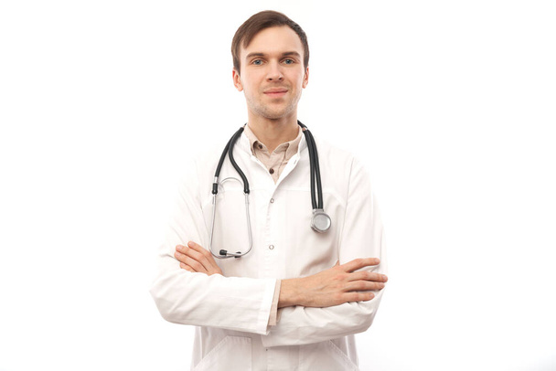 Portrait of handsome doctor in white medical coat with stethoscope on white background with copy space - Photo, image