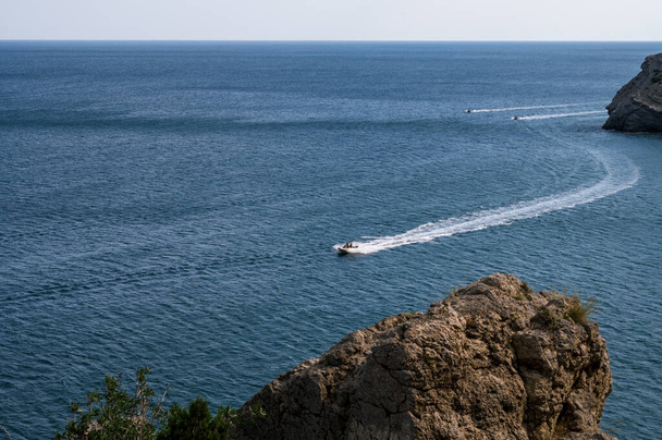 Beautiful landscape of Crimea nature. Rocky mountains in the Black sea. Pleasure boats. - Photo, Image