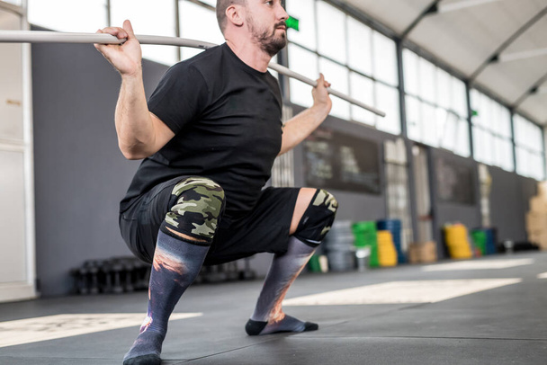 young adult man indoors gym training exercising weight lifting - Foto, Imagem