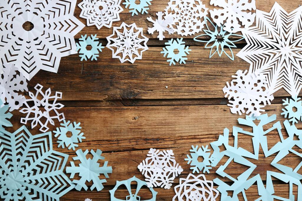 Many paper snowflakes on wooden background, flat lay. Space for text - Valokuva, kuva