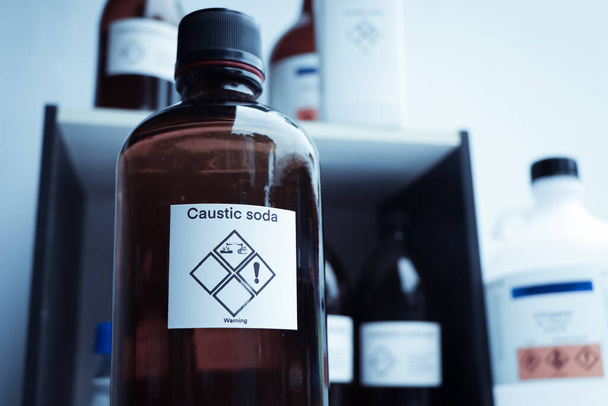 Caustic soda in bottle, chemical in the laboratory and industry - Foto, Imagem