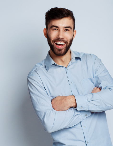 A young bearded man smiling - Fotografie, Obrázek