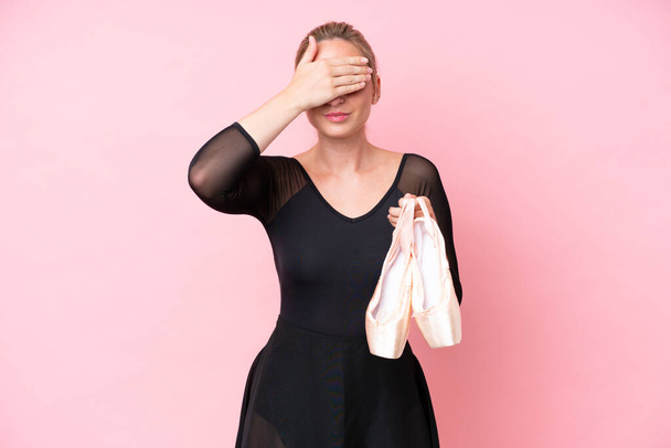 Young caucasian woman practicing ballet isolated on pink background covering eyes by hands. Do not want to see something - Foto, immagini