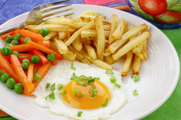 Fried egg , french fries and vegetables - Photo, image