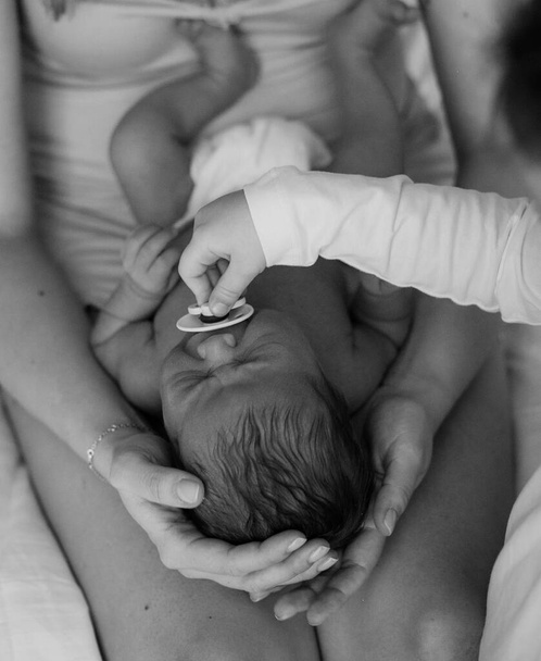 mother and newborn baby in her arms birth new life humanity light religio - Valokuva, kuva