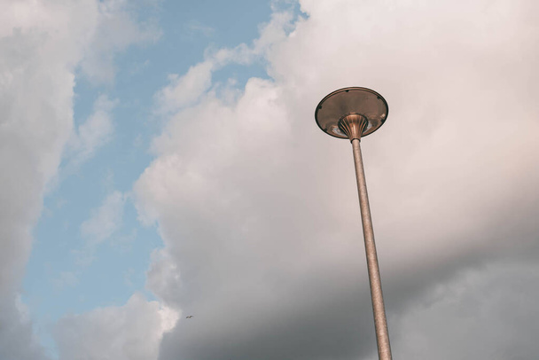 Vintage street lamp against a rainy sky. - Foto, Imagen