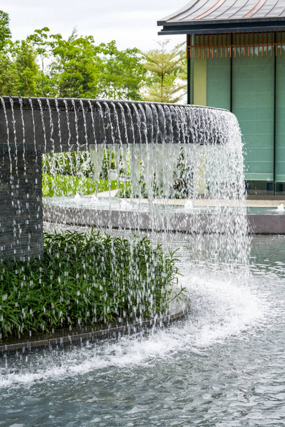 Landscape of man-made flowing water fountain in the park - Photo, image