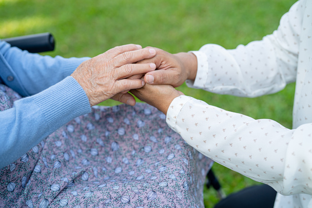 Тримаючи за руки азіатську старшу або літню жінку з любов'ю, турботою, заохоченням і співчуттям до медперсоналу, здорову медичну концепцію - Фото, зображення
