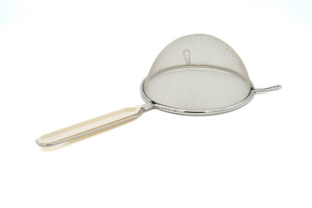 Metal sieve with white plastic handle isolated on white background. Top view. - Foto, Imagem