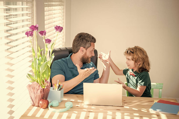 back to school. surprised father and son use modern technology at home. family blog. boy do homework with private teacher. webinar video lesson. online education on laptop. homeschooling and elearning - Photo, Image