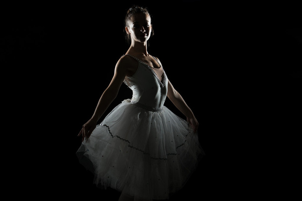 Silhouette Of Ballerina In The Black Studio - 写真・画像