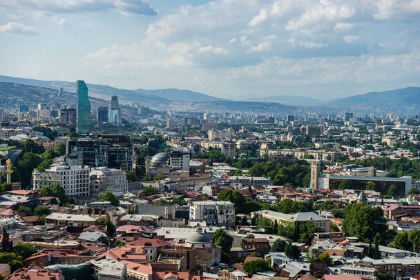 Tbilisi's cityscape with overview of Old town medieval architecture and Downtown with modern skyscarpers - Foto, Bild