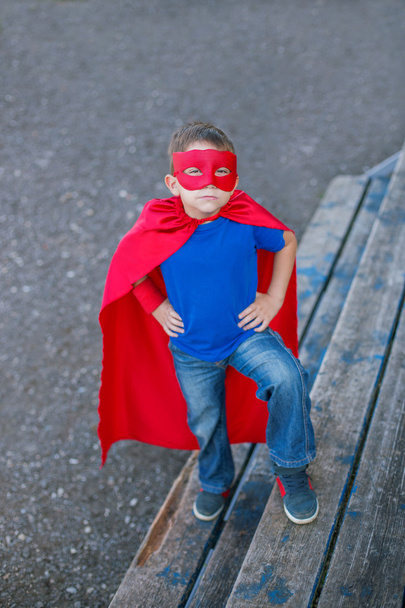 Superhero standing with hands on hips and looking up - Photo, Image