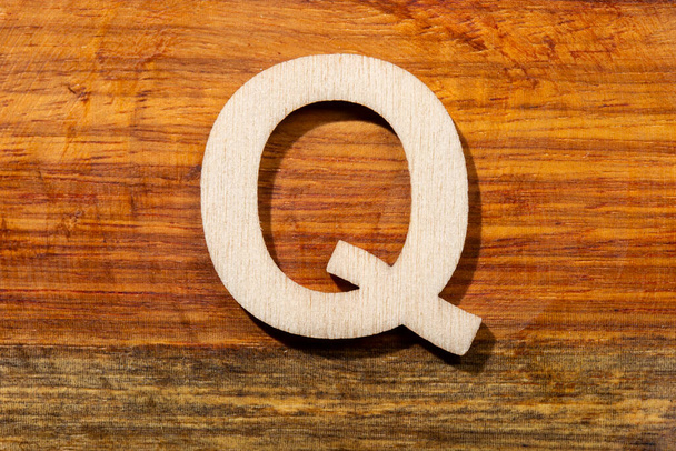 Wooden letters Q on wooden background, top view - Zdjęcie, obraz