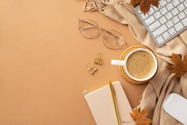 Autumn business concept. Top view photo of cup of hot drinking rattan serving mat reminder gold pen binder clips computer mouse keyboard yellow maple leaves glasses plaid on isolated beige background - Fotó, kép