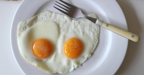 Two fried eggs on plate - Filmati, video