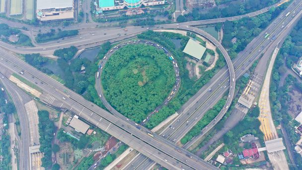 Aerial top down view on massive multi-level interchange on Jakarta city on a sunny summer day with light traffic. - Valokuva, kuva