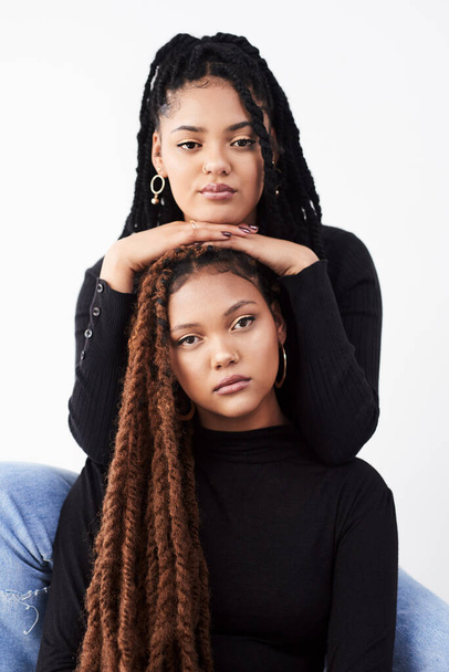 Natural hair will make you stop and stare. Studio shot of two beautiful young women posing against a grey background - Photo, Image
