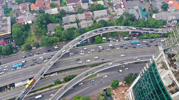 Aerial top down view on massive multi-level interchange on Jakarta city on a sunny summer day with light traffic. - Fotoğraf, Görsel