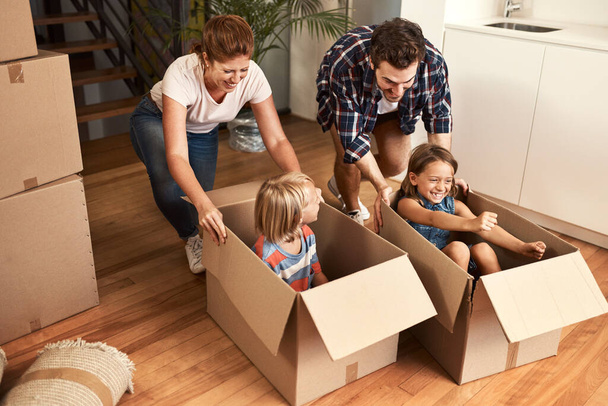 Having fun with the boxes. a young family on their moving day - Φωτογραφία, εικόνα