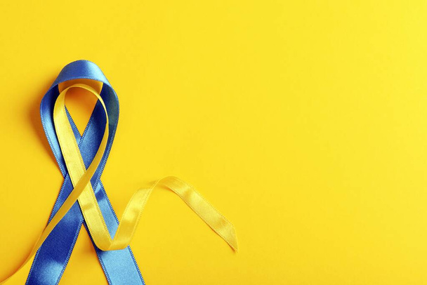 The yellow and blue ribbons on a yellow background with copy space. Ukrainian flag colors. - Photo, image