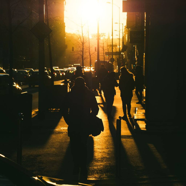 A silhouette of people walking in the streets of Budapest during the sunset - Valokuva, kuva