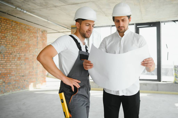 Construction concept of Engineer and Architect working at Construction Site with blue print - Фото, зображення