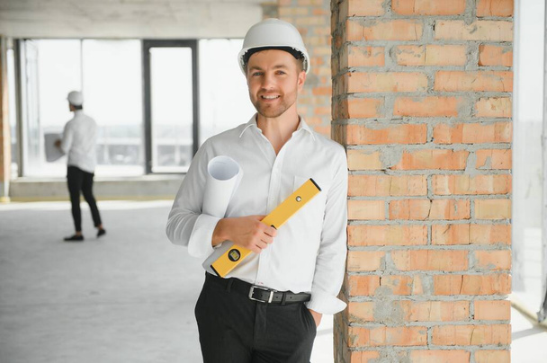 Business architect man wearing hardhat standing of a building project. - Photo, image