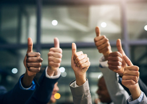Hands showing thumbs up with business men endorsing, giving approval or saying thank you as a team in the office. Closeup of corporate professionals hand gesturing in the positive or affirmative. - Zdjęcie, obraz