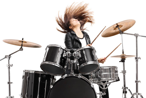 Young female drummer throwing her hair and playing drums isolated on white backgroun - Foto, imagen