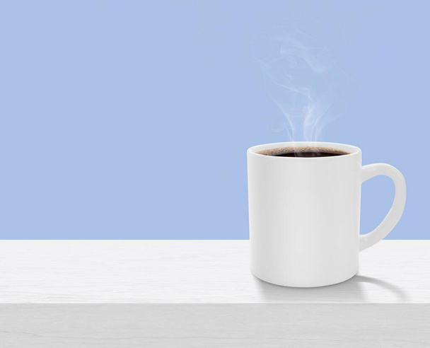 White realistic coffee cup with smoke on white wooden table with copy space - Foto, afbeelding