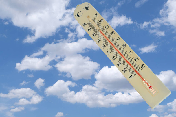 Mercury thermometer close-up on the background of the sky with clouds - Foto, Imagem