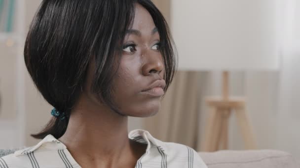 Close-up young pensive worried woman with sad expression looking away thinking about problem thoughtful serious african american girl feels loneliness anxiety frustrated upset female feeling depressed - Imágenes, Vídeo
