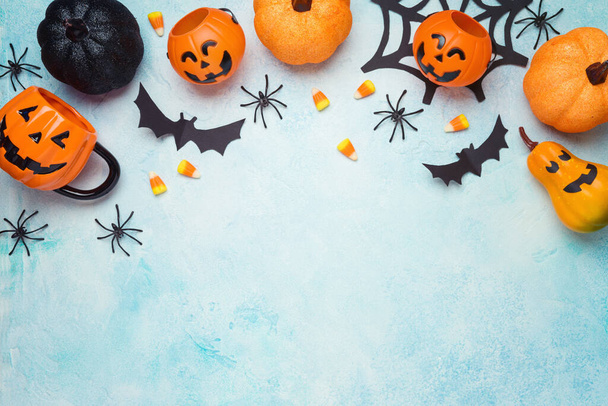 Halloween decoration concept. Background with pumpkin, spiders and candy corn. Top view, flat lay - Foto, Imagen