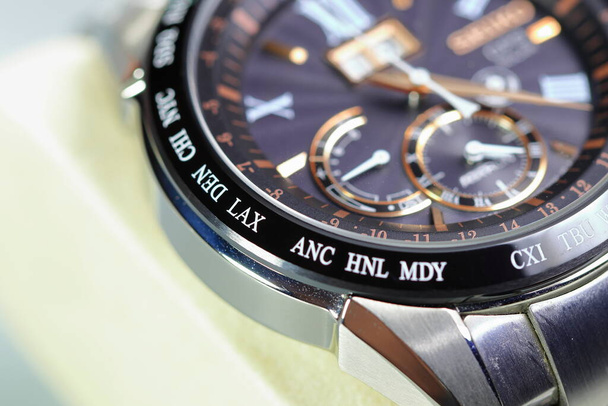close up shallow focus Time zone cities code on luxury world time watch bezel on DEN Denver, LAX Los Angeles. - Foto, Imagen