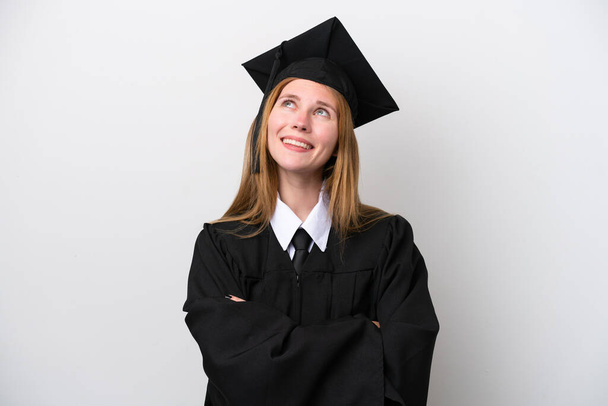 Young university graduate English woman isolated on white background looking up while smiling - Photo, image