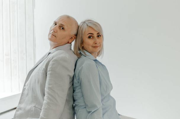 a man and a woman are sitting in a white room - Photo, image