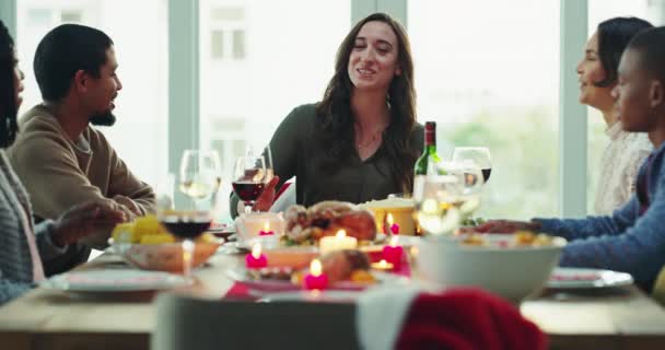 Friends, food and celebrations while sharing a toast with wine glasses and sitting at a dining table together. Diverse group talking and bonding during a dinner party at home, restaurant or a hotel. - Imágenes, Vídeo