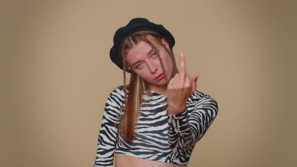 Aggressive crazy hooligan young woman showing around her middle fingers, demonstrating protest with impolite rude gesture of disrespect, rejecting communication. Adult girl on beige studio background - Felvétel, videó