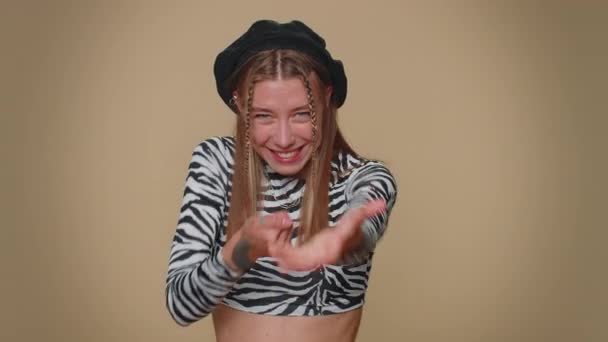 Lovely pretty young woman mime pulling an imaginary unreal invisible rope, puts lot of effort into showing how enduring, strong she is. Adult stylish female girl isolated on beige studio background - Felvétel, videó