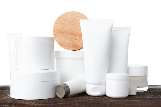 Set of different creams on wooden table against white background - Fotoğraf, Görsel