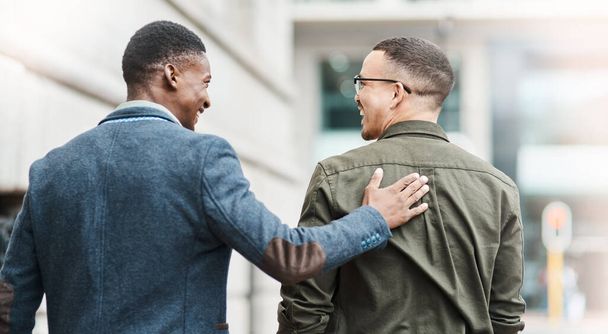 Support, trust and motivation between friends, coworkers and casual men feeling happy about job opportunity or promotion while walking in city during lunch break. Proud guy congratulating his buddy. - 写真・画像