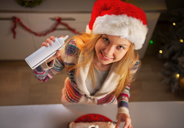 Portrait of happy teenager girl in santa hat with whipped cream - Zdjęcie, obraz
