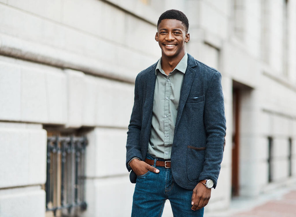 Stylish, trendy and handsome businessman walking to work in the city alone. Portrait of a cool black male entrepreneur commuting to his job and looking happy, carefree and cheerful in the morning. - Фото, изображение
