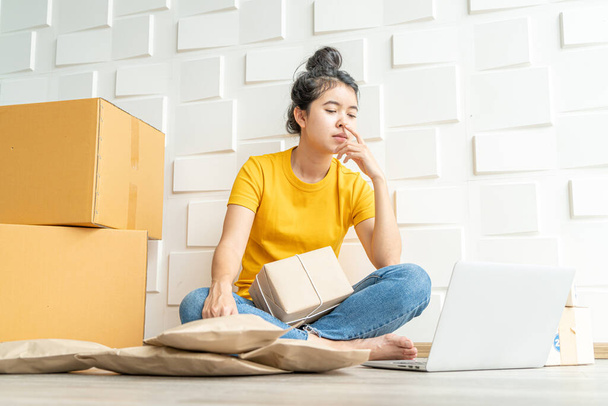 young Asian woman feeling stress or depress in front of her laptop - online selling concept - Fotoğraf, Görsel