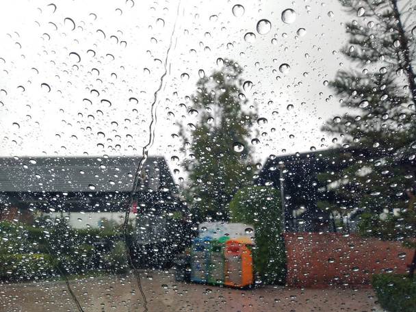 Rain drops on windshield concept Heavy rain makes visibility bad Danger Weather forecast Meteorological Department - Foto, imagen